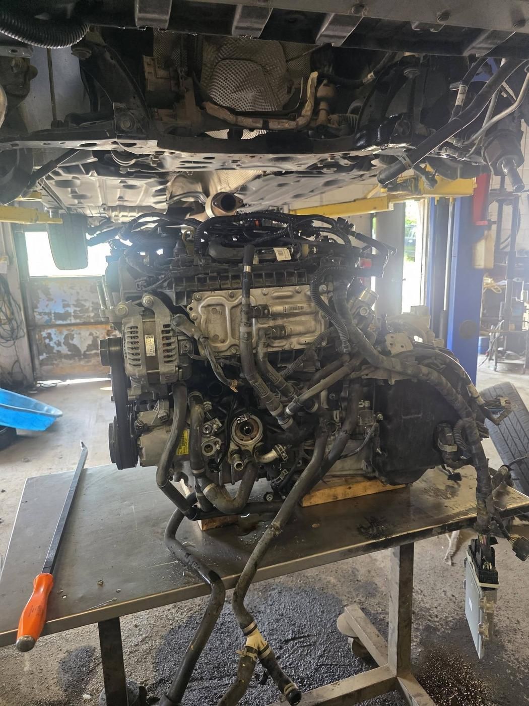 The old engine out from under the vehicle.